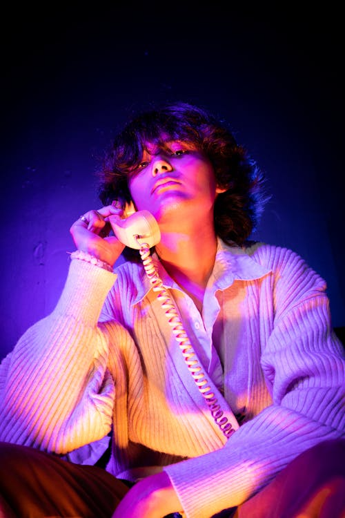 Creator on phone in neon light